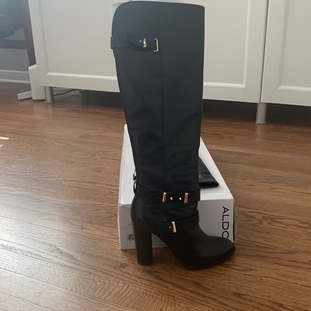 Aldo boots in black with gold zippers and gold/black straps on the sides.